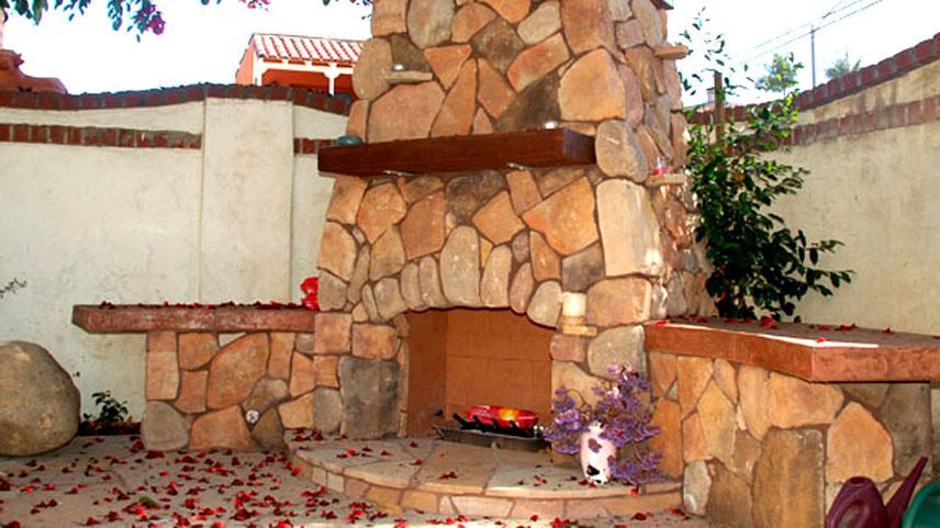 Masonry (Outdoor fireplace with natural stone hearthe and precast dressfield and river rock combo).jpg